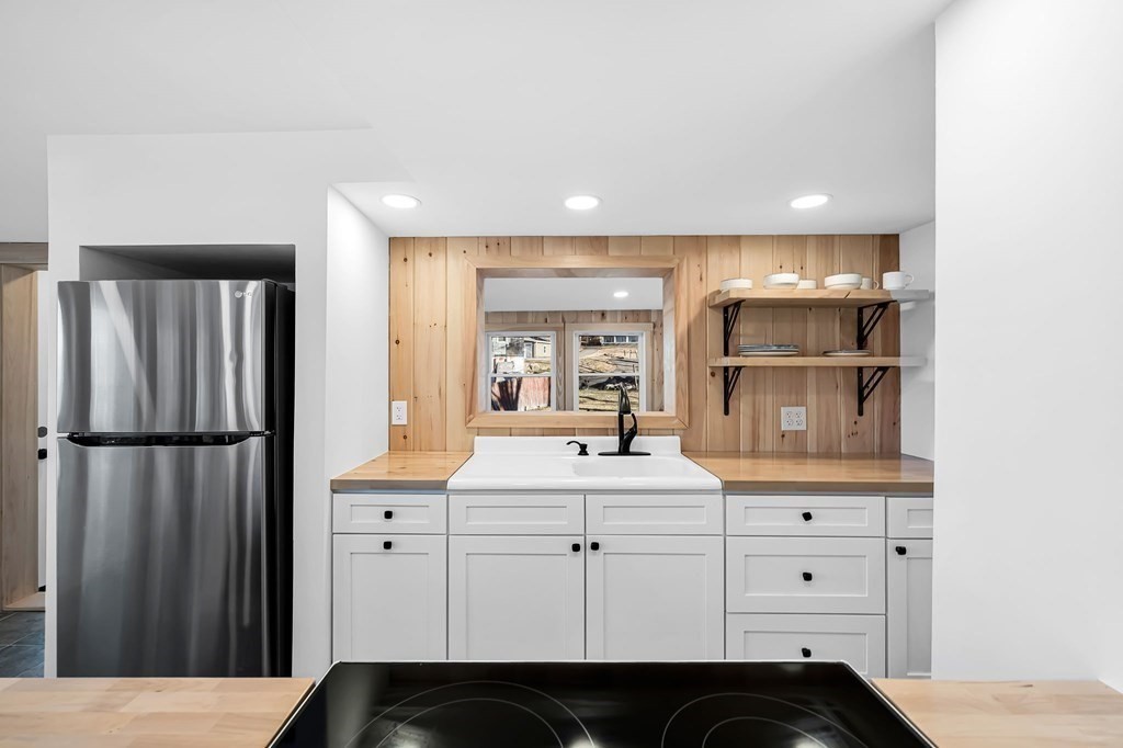 4 Brows Beach Road Wales, MA 01081 - Photo 10 of 41 a kitchen with a refrigerator sink and cabinets