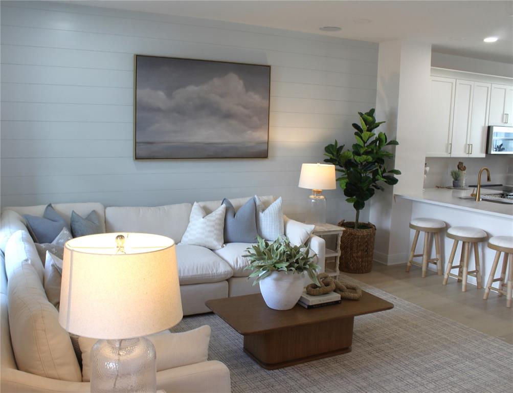 17736 Broadleaf Loop Venice, FL 34293 - Photo 6 of 16 a living room with furniture and a potted plant