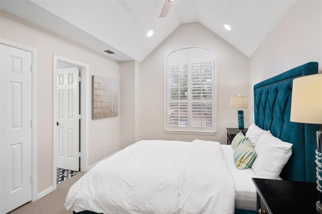 14604 Hemingway Court Addison, TX 75001 - Photo 16 of 27 a bedroom with a bed and a table
