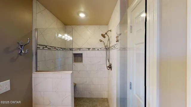 a bathroom with a glass shower door
