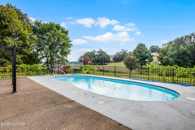 a view of a swimming pool with an outdoor space and seating area