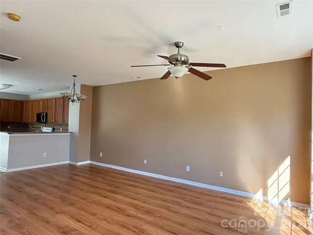 a view of a kitchen with a sink cabinets and wooden floor