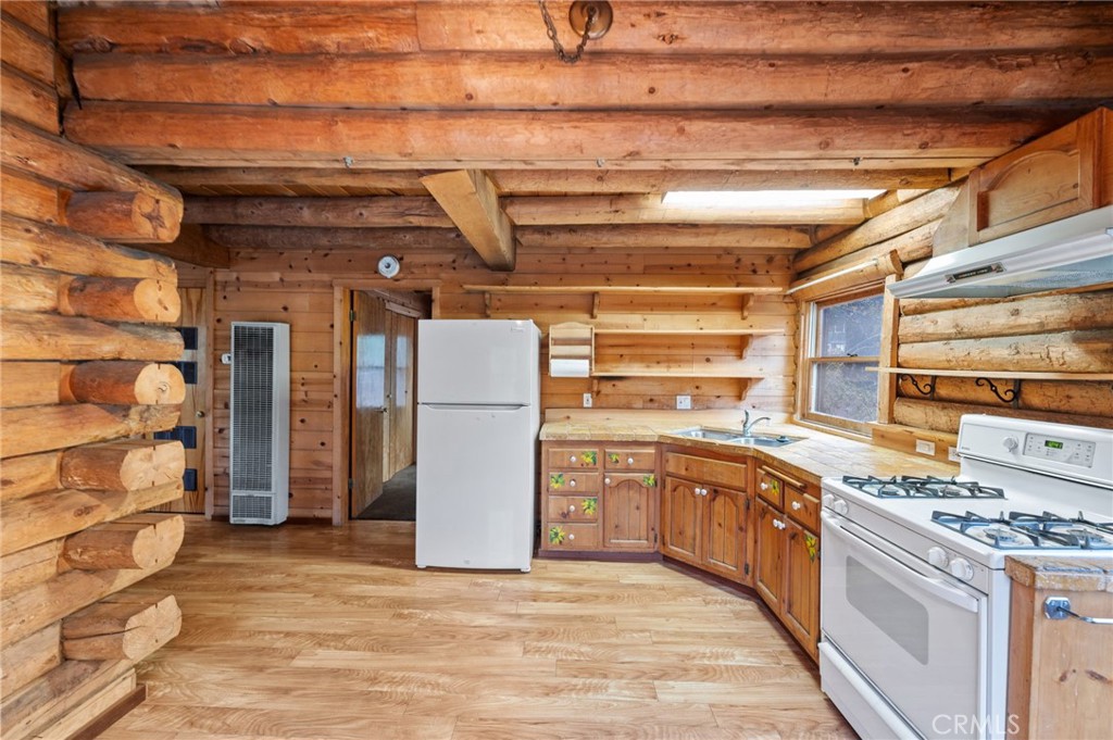 53645 Country Club Drive Idyllwild, CA 92549 - Photo 9 of 33 a kitchen with cabinets and stainless steel appliances