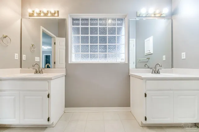 a bathroom with a sink vanity and a mirror
