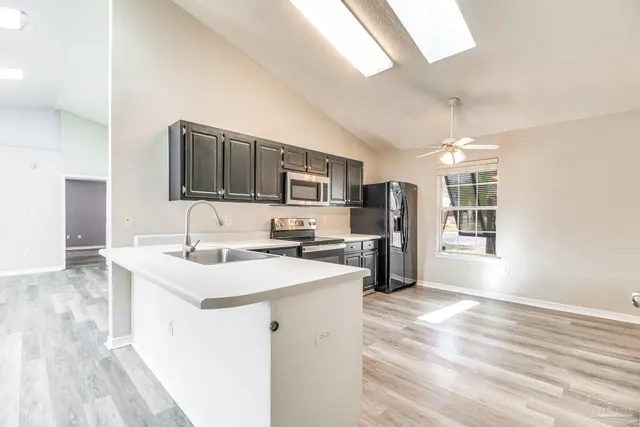 a kitchen with a sink microwave and refrigerator