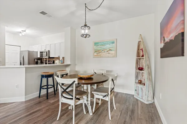 a view of a dining room with furniture and wooden floor