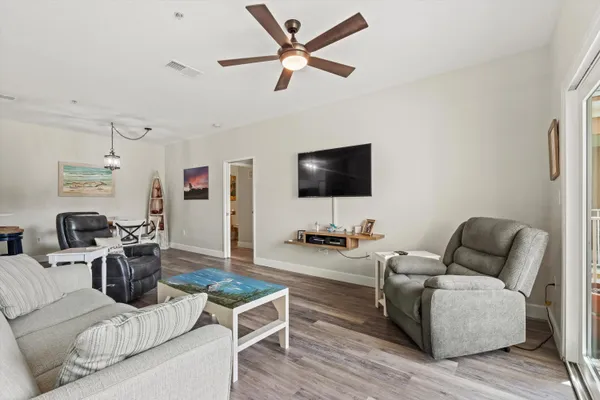 a living room with furniture and kitchen view