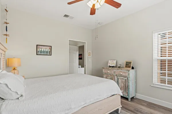 a bedroom with a large bed and a window