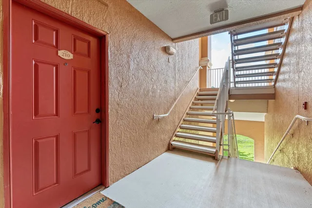 a view of a entryway door with stairs