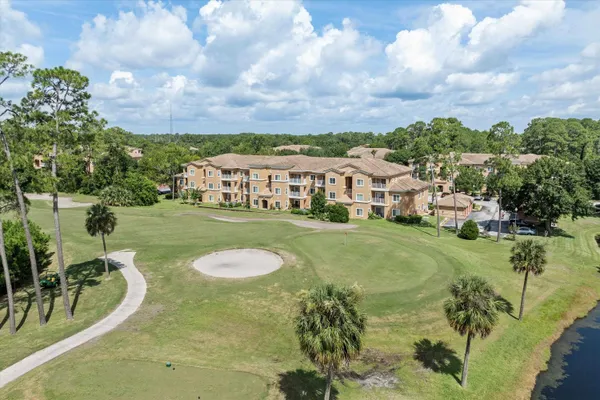 a view of residential houses with yard and swimming pool