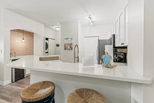 a kitchen with stainless steel appliances kitchen island granite countertop a sink and cabinets