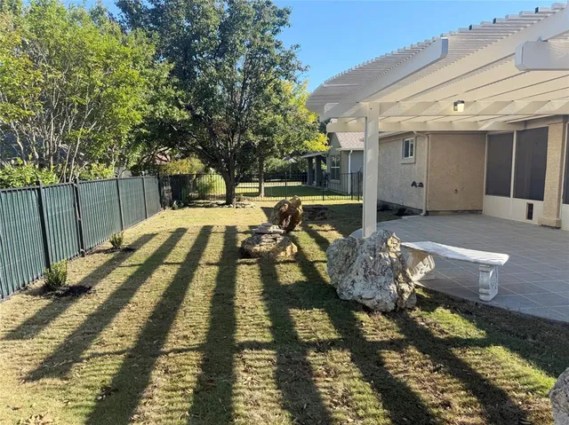 a view of a kitchen with kitchen island a sink wooden floor and a chandelier