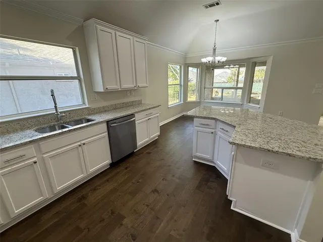 a view of a kitchen cabinets and wooden floor