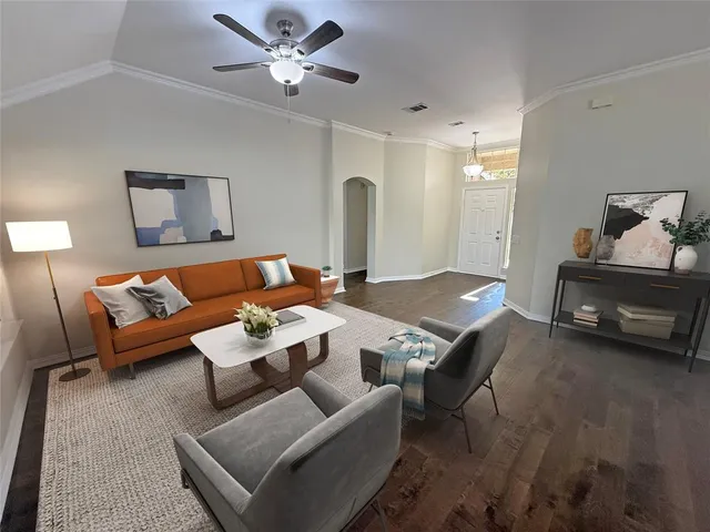 a living room with furniture and a chandelier