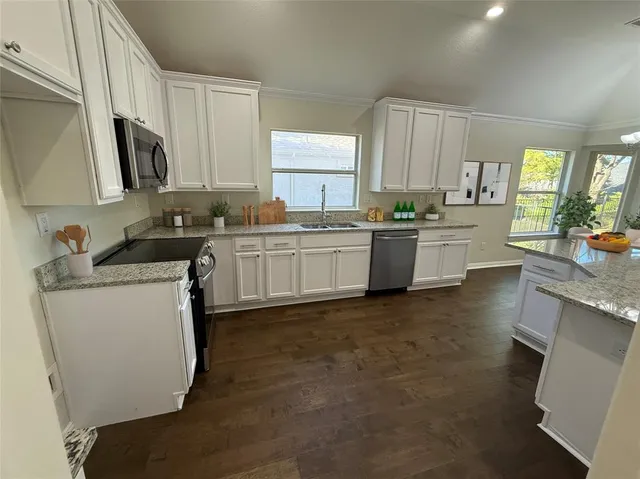 a kitchen with a sink stove and cabinets