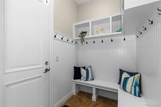a view of a hallway with wooden floor and windows