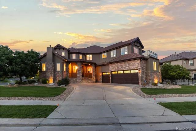 an aerial view of ocean and residential houses with outdoor space