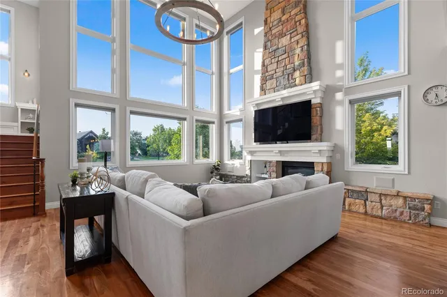 a living room with furniture a large window and a flat screen tv