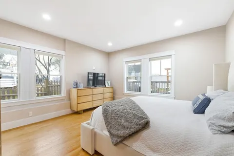 a spacious bedroom with a bed and a couch