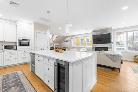 a large kitchen with stainless steel appliances kitchen island granite countertop a stove and a sink