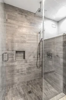 a view of a patio with a table chairs and a floor to ceiling window