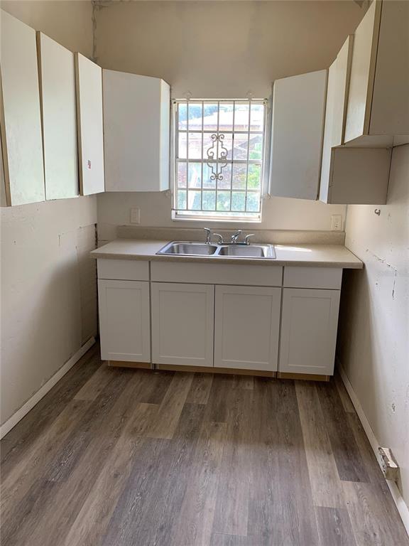 417 Maple Street Daytona Beach, FL 32114 - Photo 5 of 6 a room with wooden floor and window