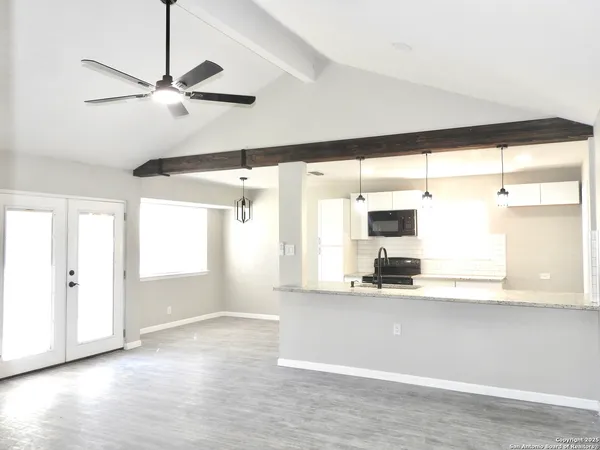 a view of a kitchen with a dishwasher and a large window with kitchen view