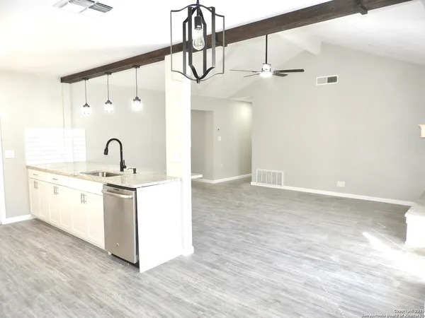 a kitchen with kitchen island a sink and wooden floor