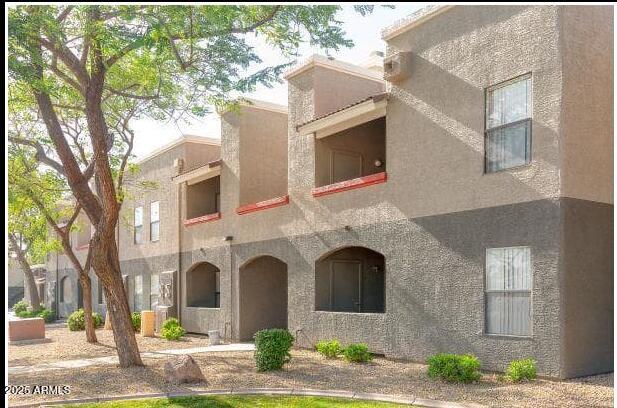 5740 North 59th Avenue, Unit 2 Glendale, AZ 85301 - Photo 1 of 11 a front view of a house with yard