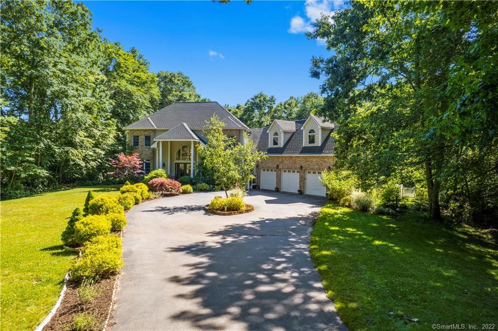 a view of a house with swimming pool lawn chairs and a yard