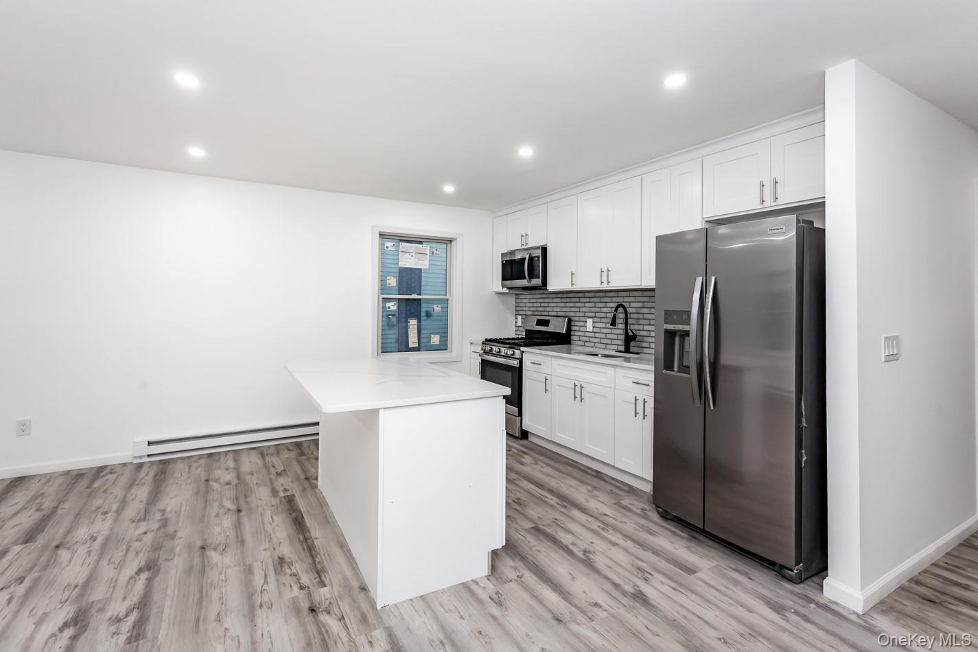 300 Highland Avenue, Unit 5 Peekskill, NY 10566 - Photo 11 of 17 a kitchen with a refrigerator a sink and cabinets