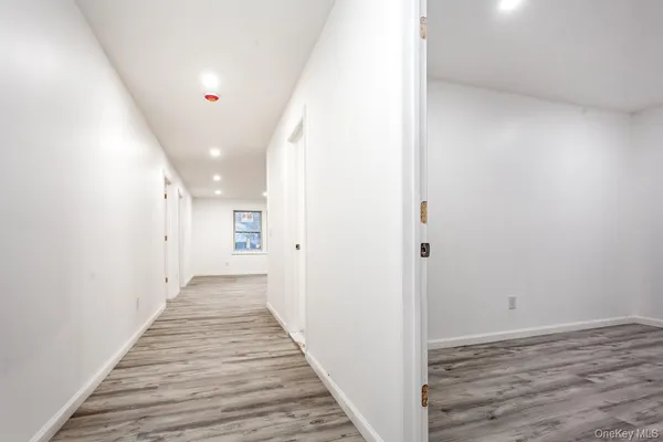 a view of a hallway with wooden floor