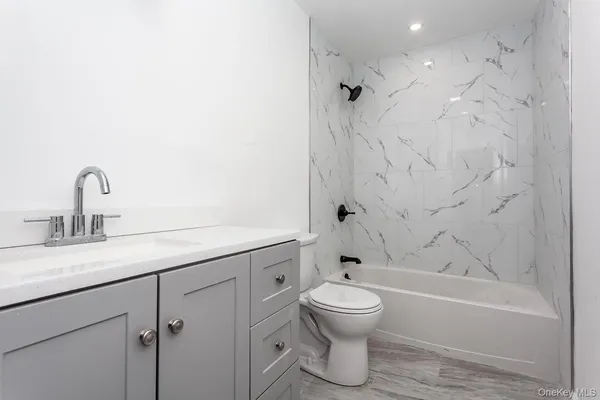 a bathroom with a toilet sink and bathtub
