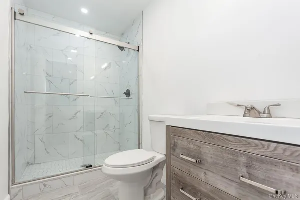 a bathroom with a sink mirror vanity and toilet
