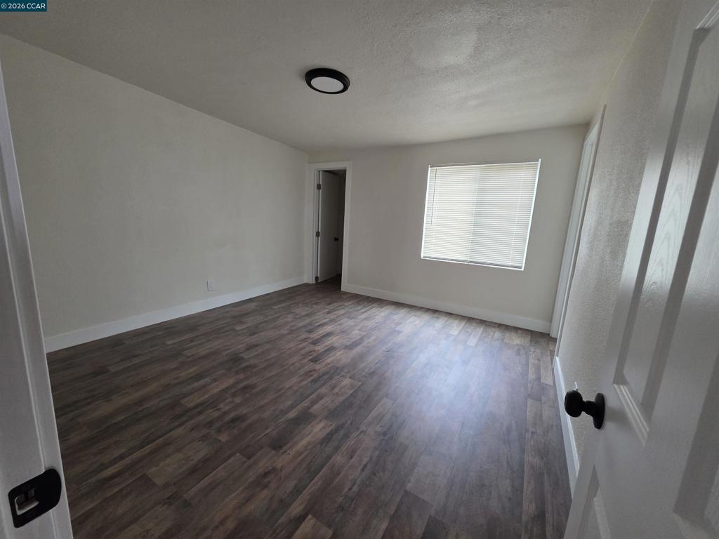 139 Ambrose Avenue Bay Point, CA 94565 - Photo 3 of 13 an empty room with wooden floor and windows