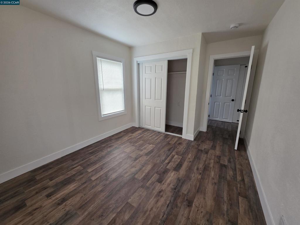139 Ambrose Avenue Bay Point, CA 94565 - Photo 5 of 13 a view of an empty room with wooden floor and a window