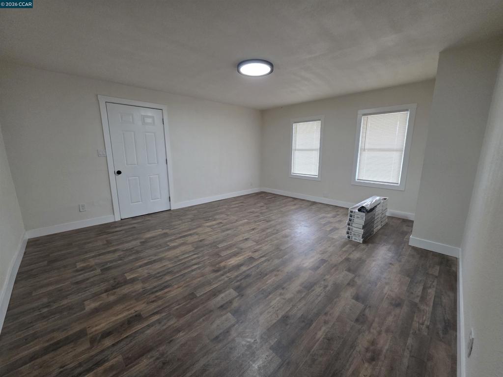 139 Ambrose Avenue Bay Point, CA 94565 - Photo 6 of 13 an empty room with wooden floor and windows