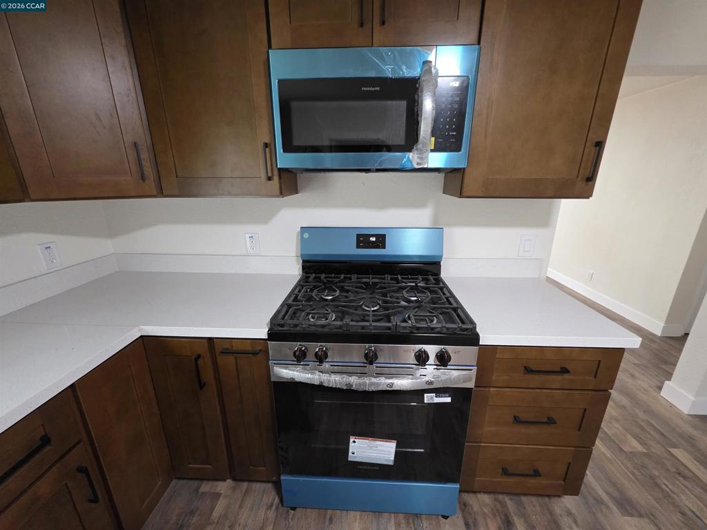 139 Ambrose Avenue Bay Point, CA 94565 - Photo 8 of 13 a kitchen with a stove and a microwave