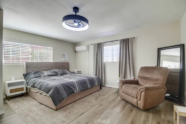 a bedroom with a bed couch and window