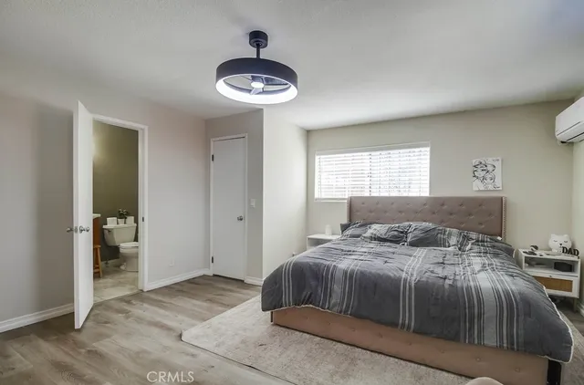 a bedroom with a large bed and a chandelier