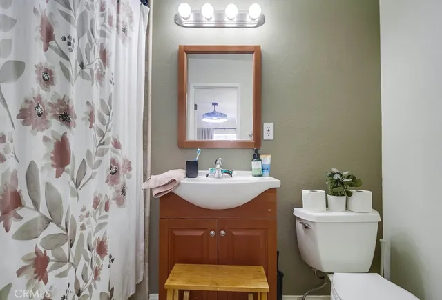 a bathroom with a sink a mirror and a toilet
