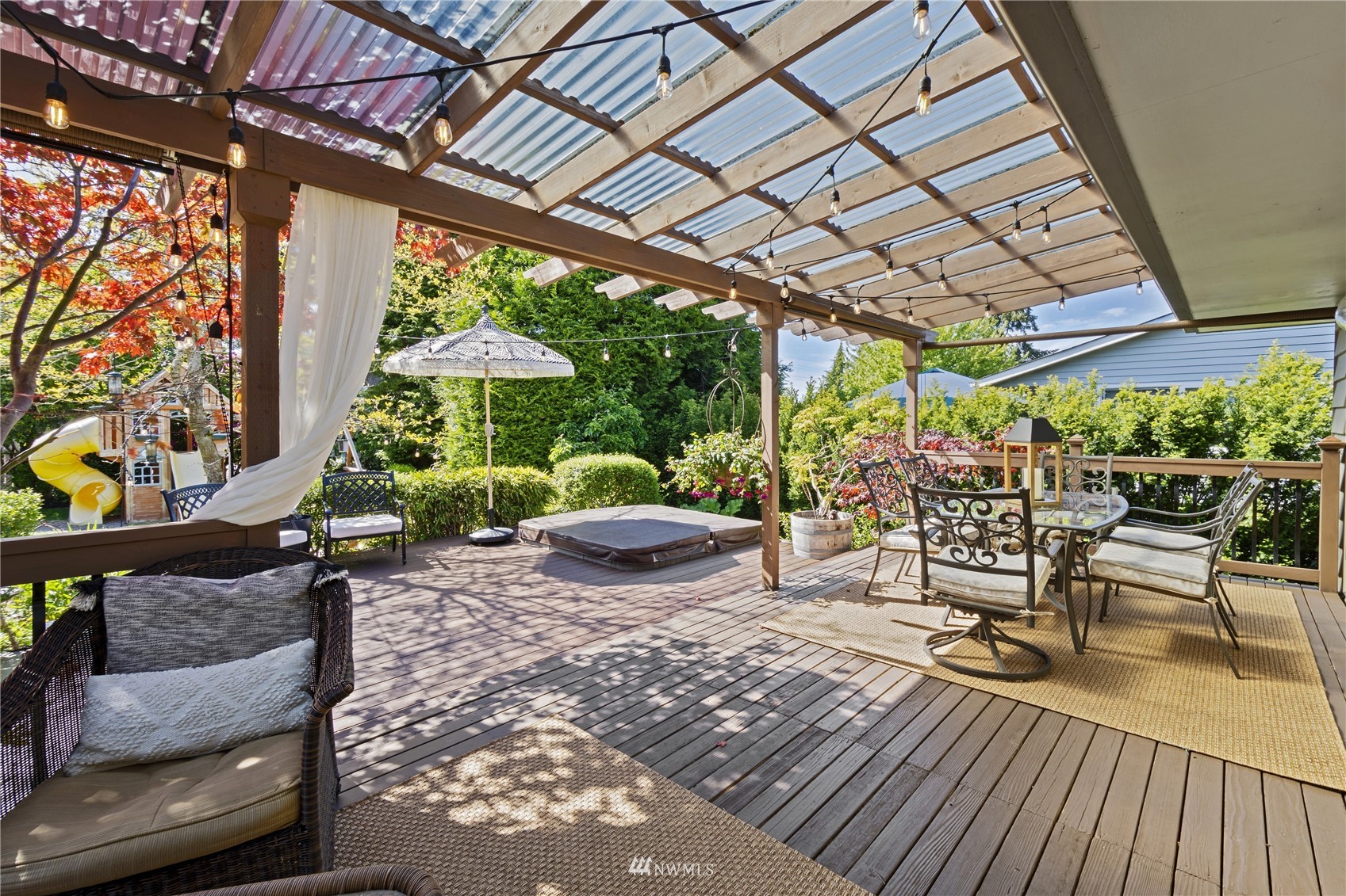 5134 West Highland Road Everett, WA 98203 - Photo 23 of 29 a view of a patio with a table chairs and a backyard