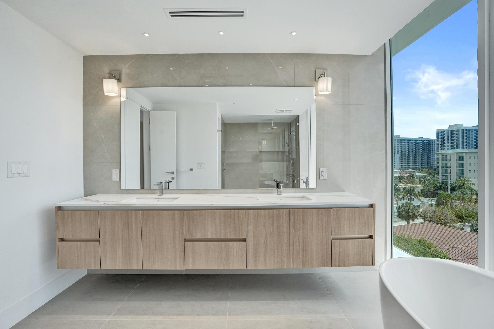 407 North Riverside Drive, Unit 605 Pompano Beach, FL 33062 - Photo 27 of 93 a bathroom with a sink and a mirror