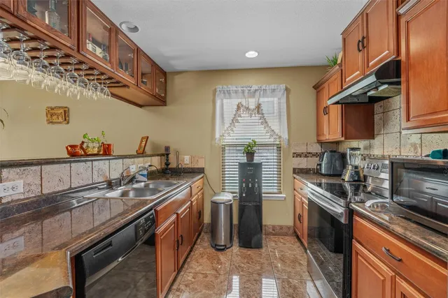 a kitchen with stainless steel appliances granite countertop a stove and a sink