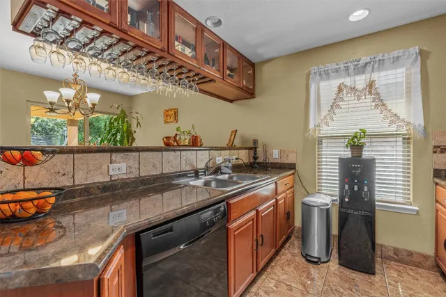 a kitchen with stainless steel appliances granite countertop a sink and a counter space