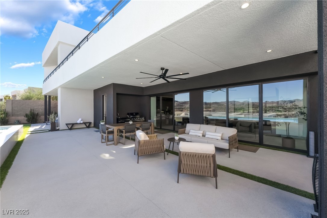 33 Falling Ridge Lane Henderson, NV 89011 - Photo 14 of 70 View of patio / terrace with an outdoor kitchen, a ceiling fan, an outdoor living space, a mountain view, and outdoor dining space