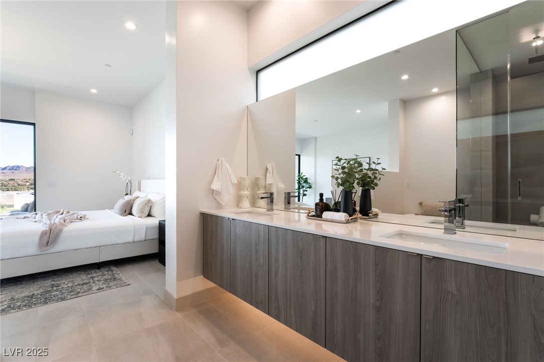33 Falling Ridge Lane Henderson, NV 89011 - Photo 28 of 70 Ensuite bathroom featuring double vanity, recessed lighting, light tile patterned floors, and a shower stall
