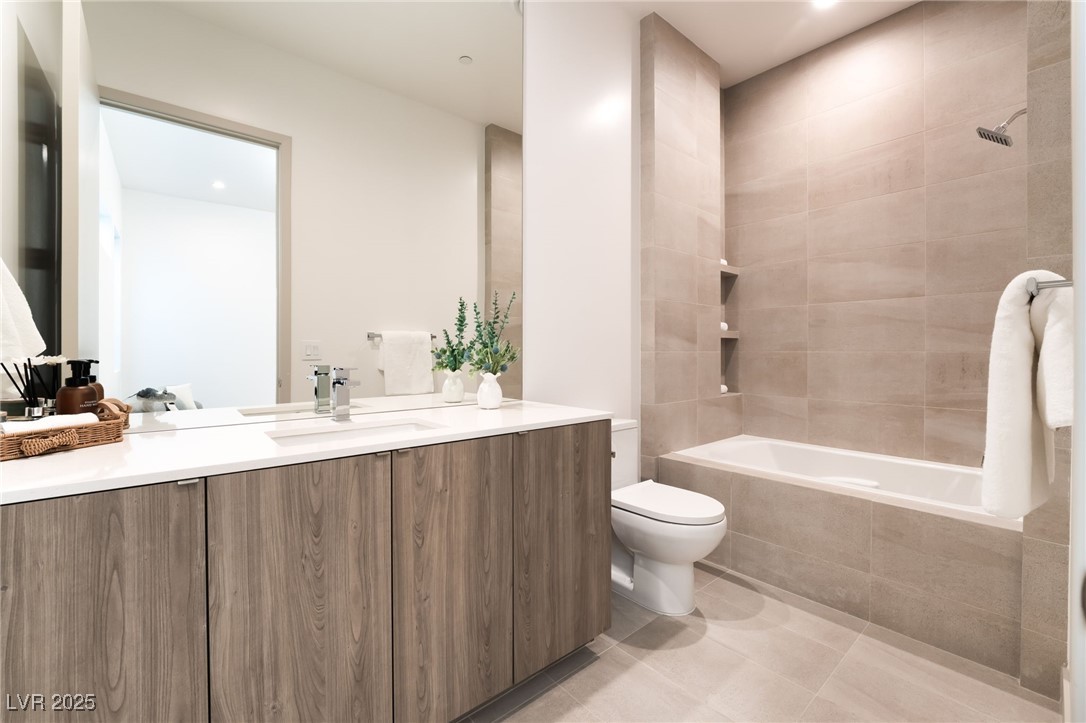 33 Falling Ridge Lane Henderson, NV 89011 - Photo 31 of 70 Bathroom with vanity, light tile patterned floors, tiled shower / bath combo, and recessed lighting