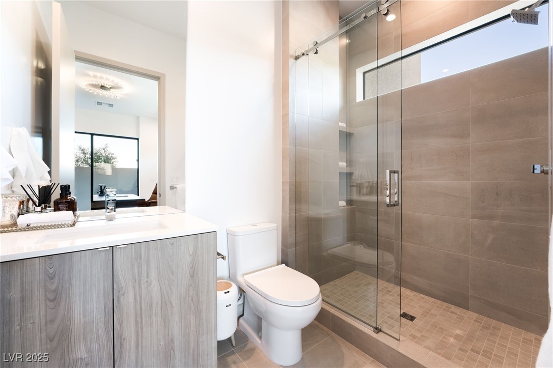 33 Falling Ridge Lane Henderson, NV 89011 - Photo 34 of 70 Ensuite bathroom with a shower stall, vanity, and tile patterned floors