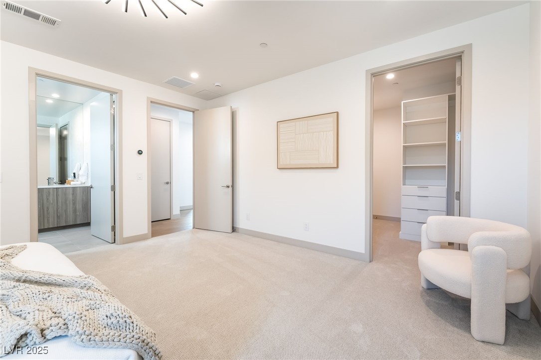 33 Falling Ridge Lane Henderson, NV 89011 - Photo 39 of 70 Bedroom featuring a spacious closet, recessed lighting, light carpet, and ensuite bathroom